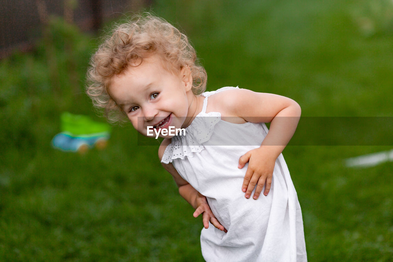 Portrait of cute girl standing outdoors