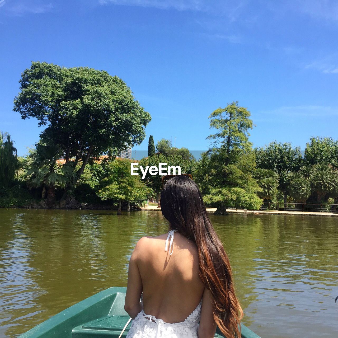 Rear view of woman on boat in river