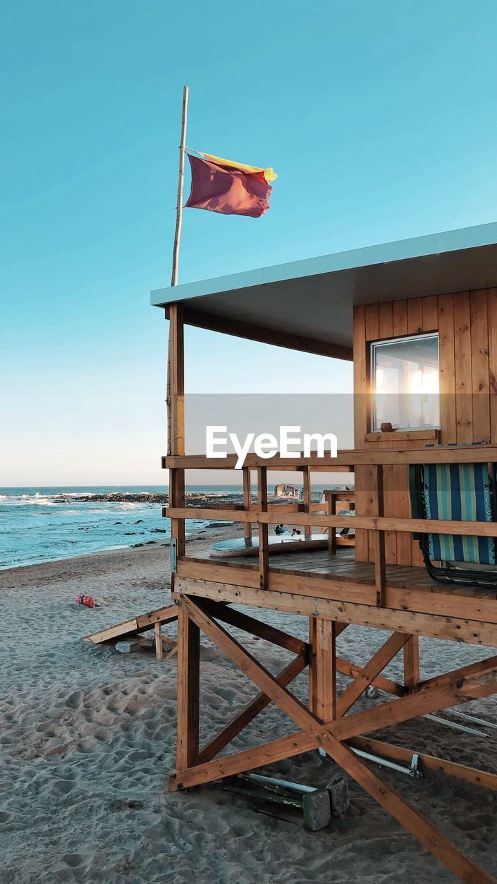 BUILT STRUCTURE ON BEACH AGAINST CLEAR SKY