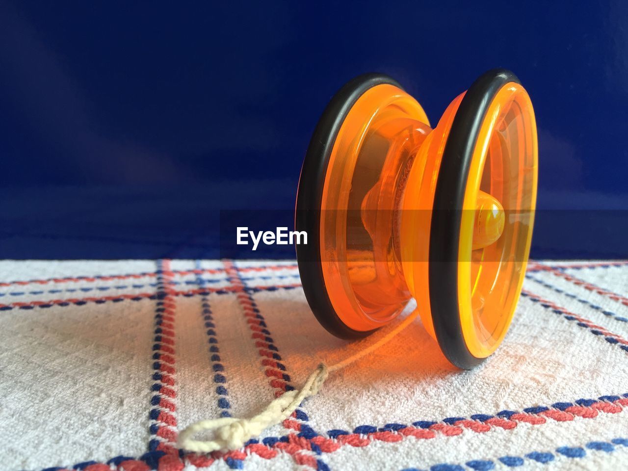 Close-up of orange yo-yo toy on table