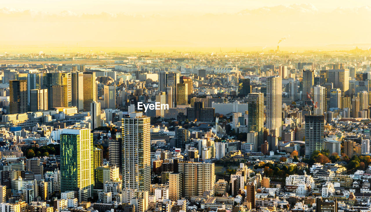 Aerial view of city buildings during sunset