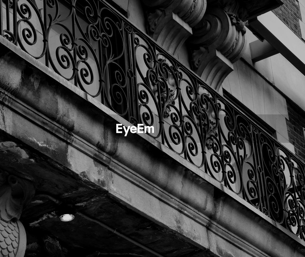 LOW ANGLE VIEW OF BUILDING BY RAILING