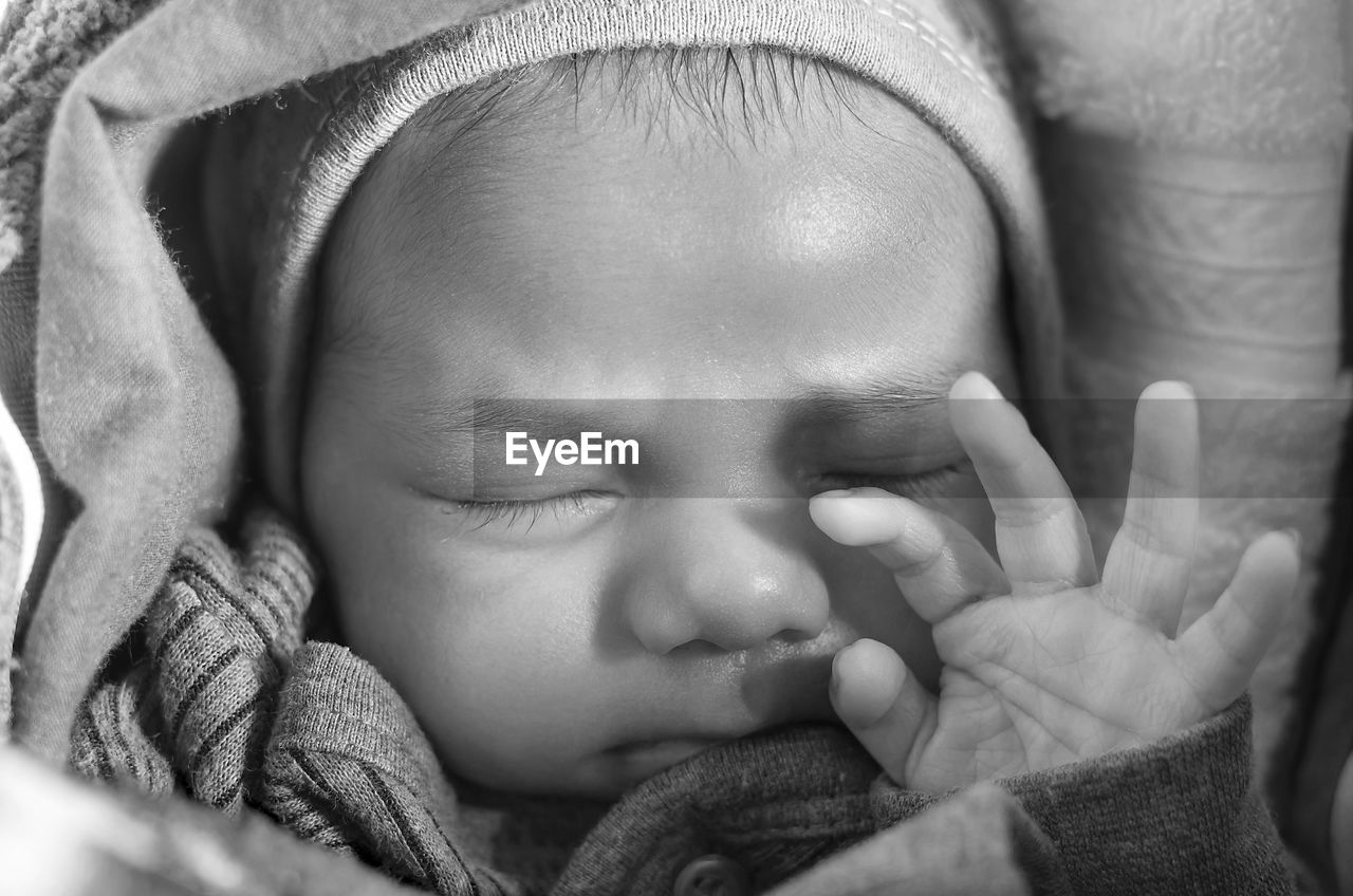 Close-up of baby boy sleeping on bed