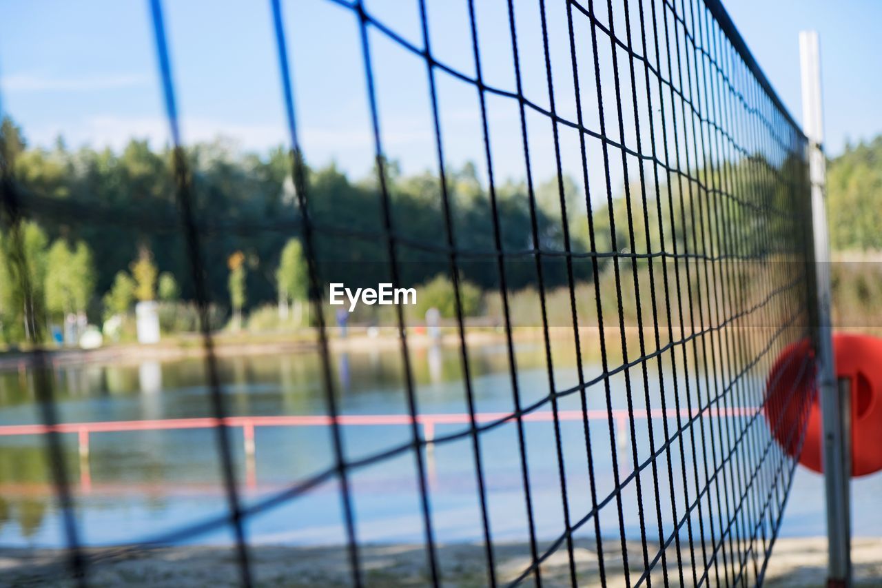 Close-up of volleyball net on beach against sky