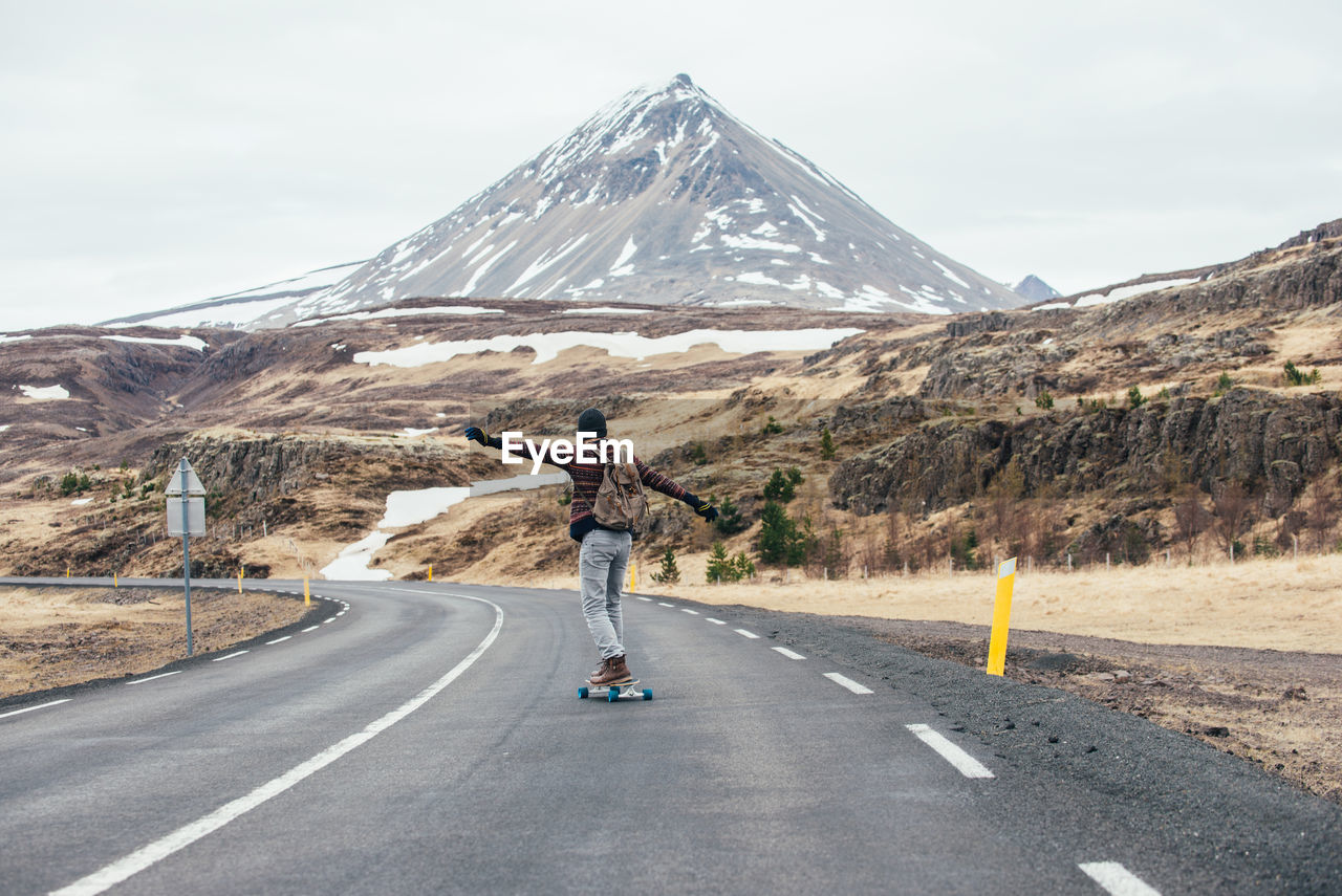 Man skateboarding on highway