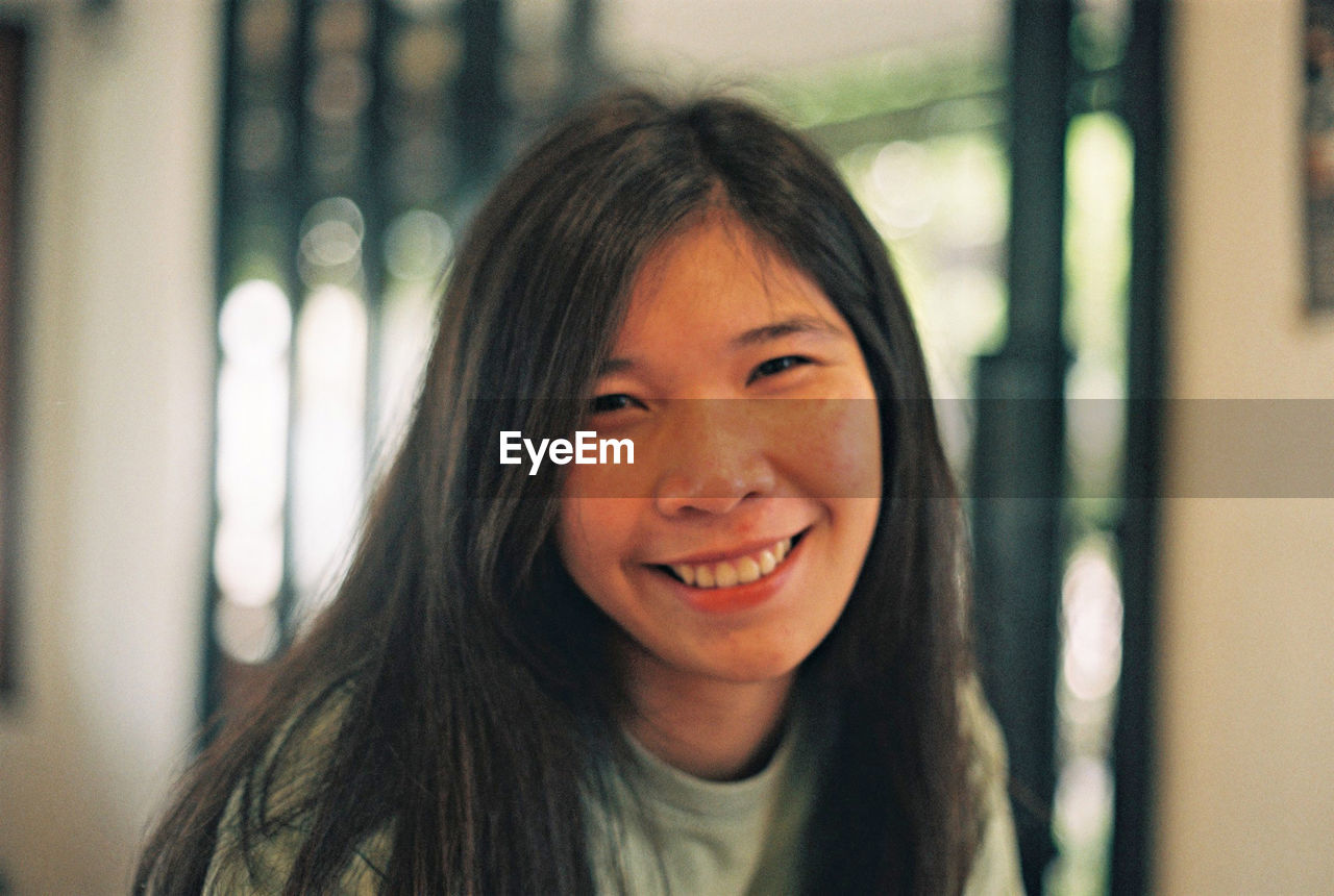 Portrait of smiling young woman at home