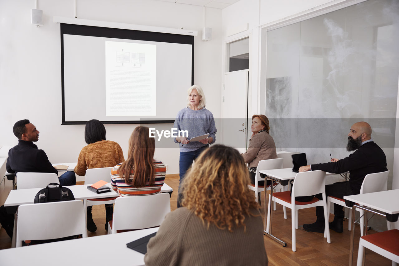 Woman giving presentation at seminar