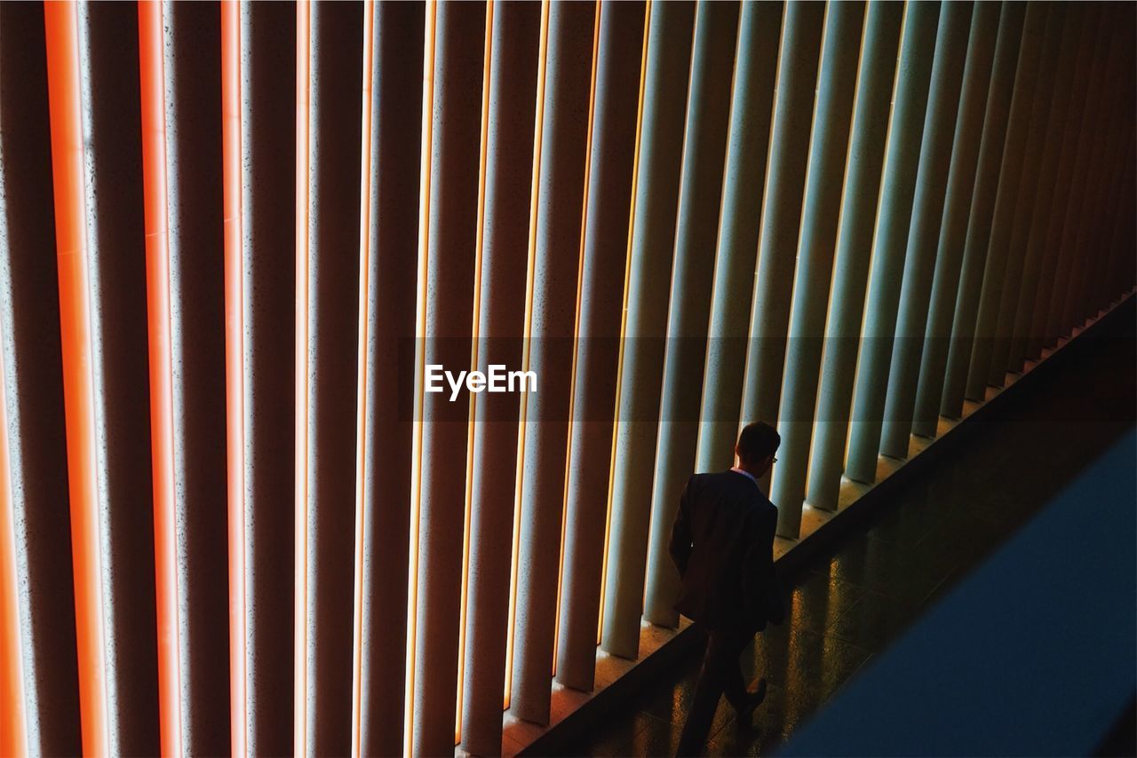 High angle view of businessman walking in corridor