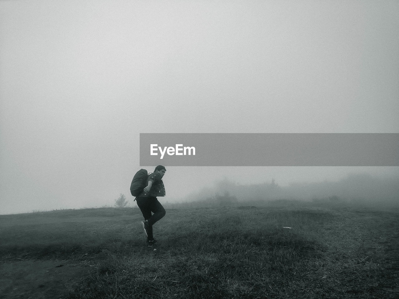 People on field during foggy weather