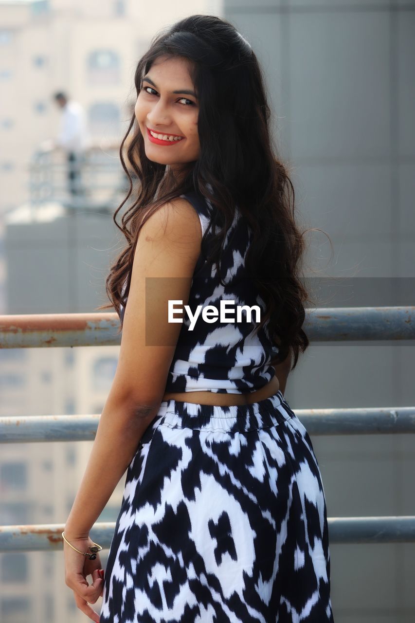 Portrait of a smiling young woman standing outdoors