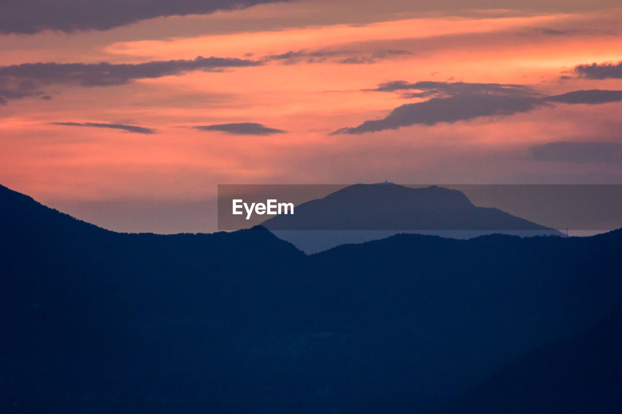 Scenic view of silhouette mountains against sky during sunset