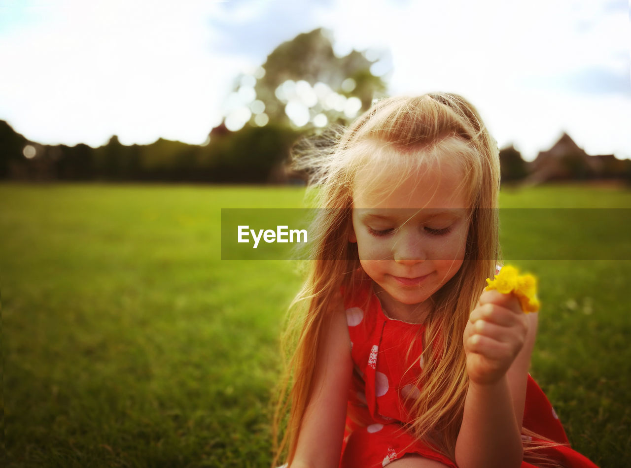 Portrait of girl on grassy field