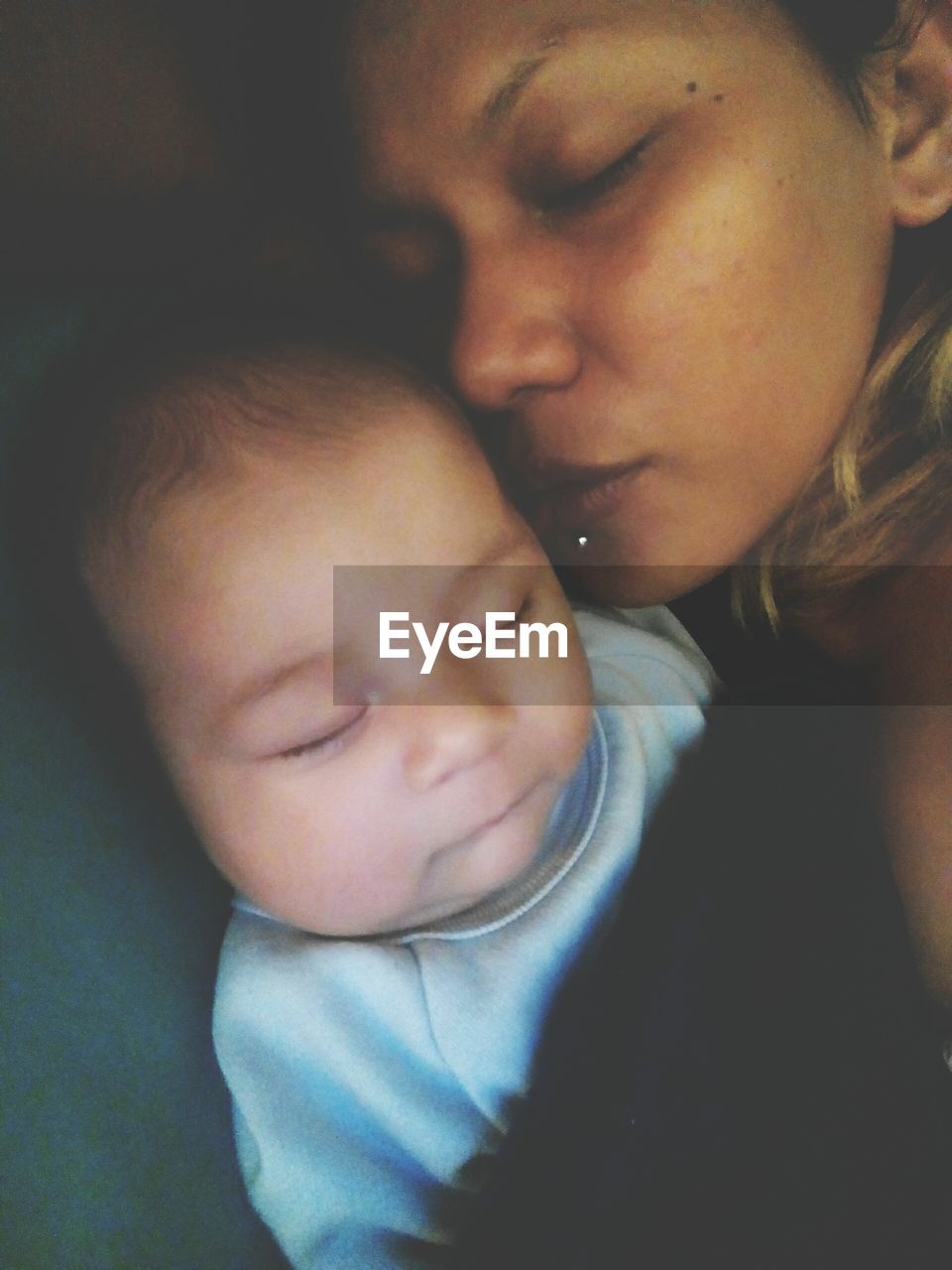 CLOSE-UP OF BABY BOY SLEEPING ON SOFA