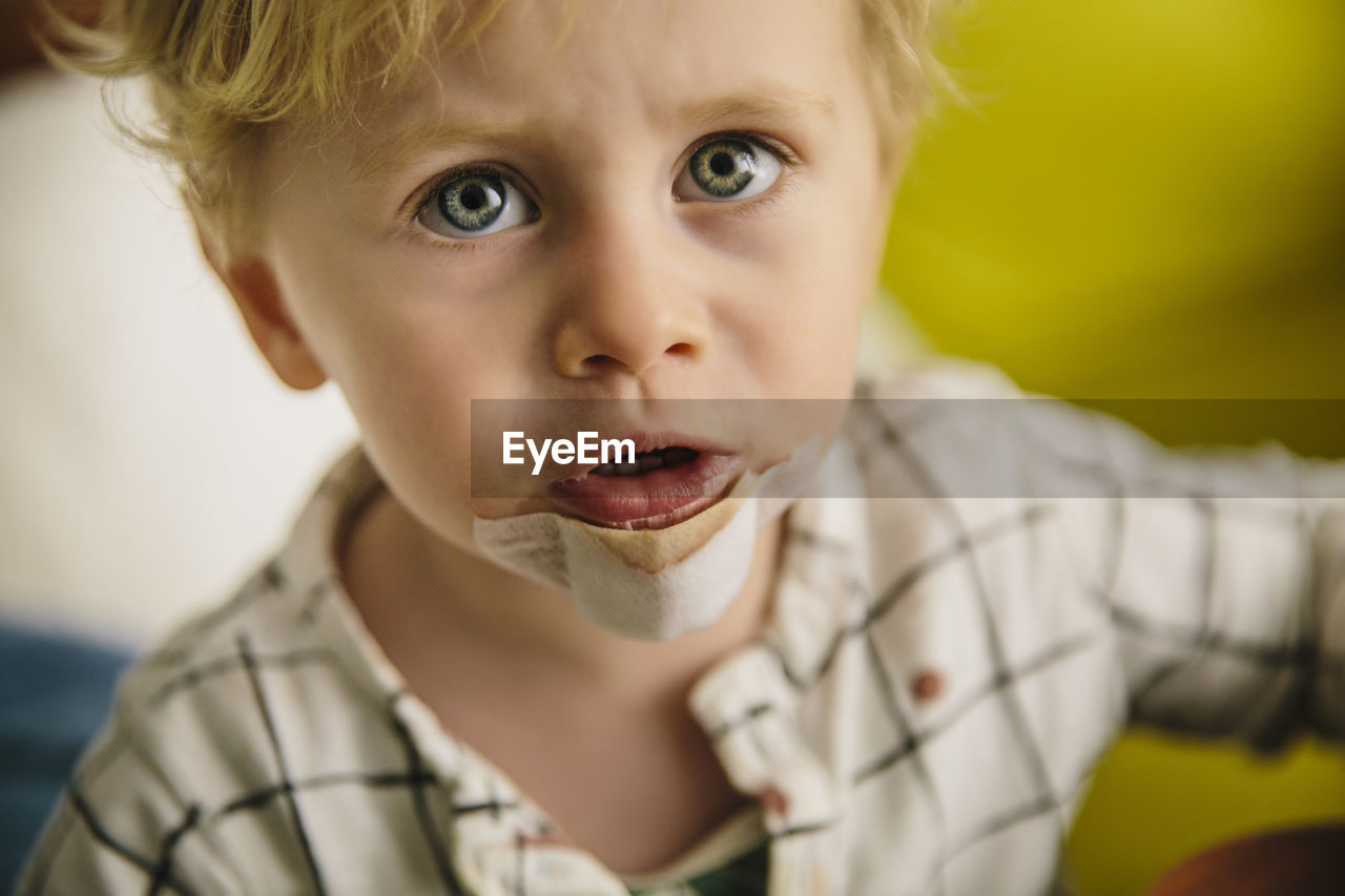 Portrait of little boy with patch on his chin