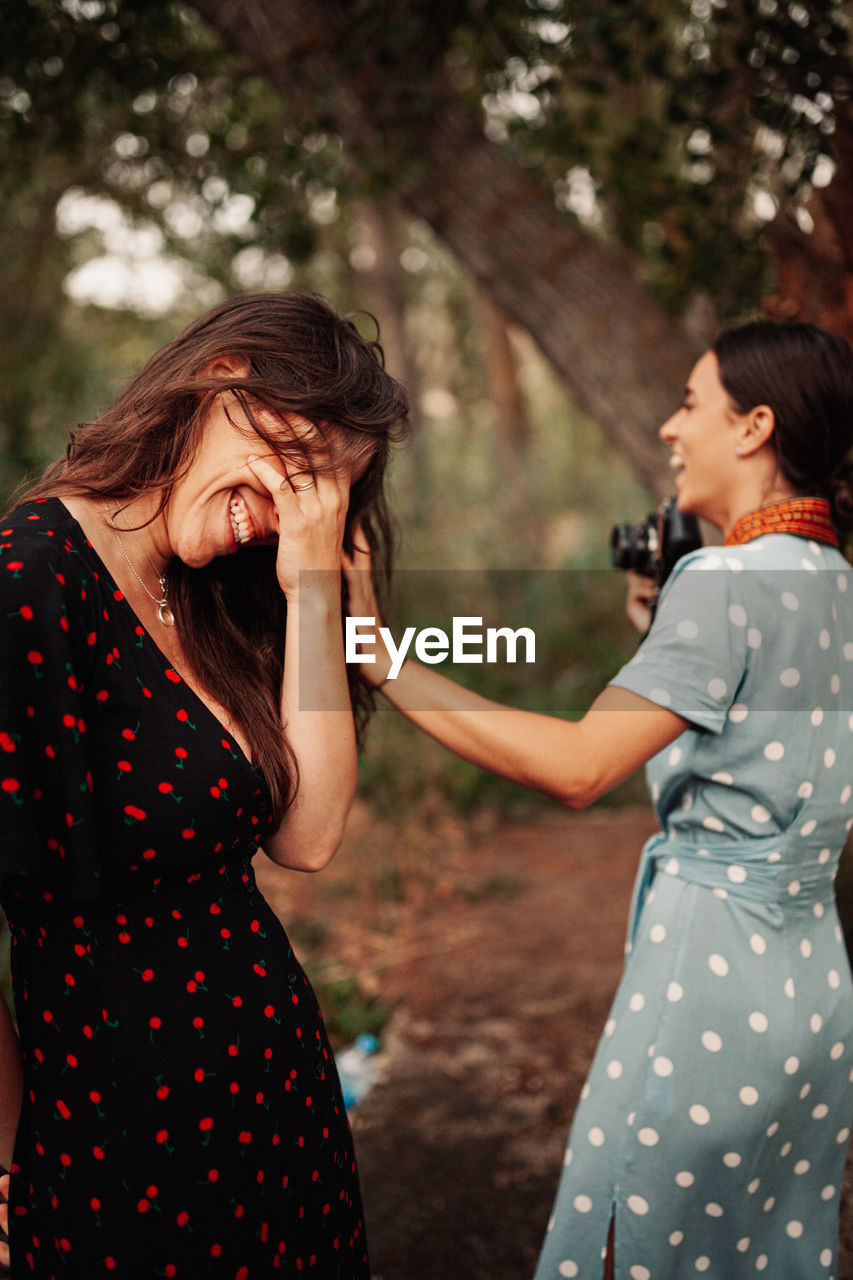 Young smiling lesbian couple standing outdoors