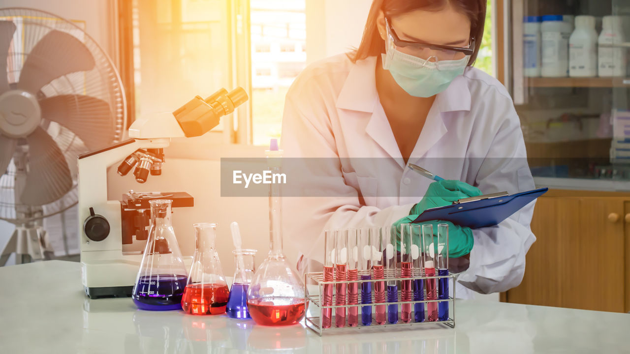 Close-up of scientist examining chemical in laboratory