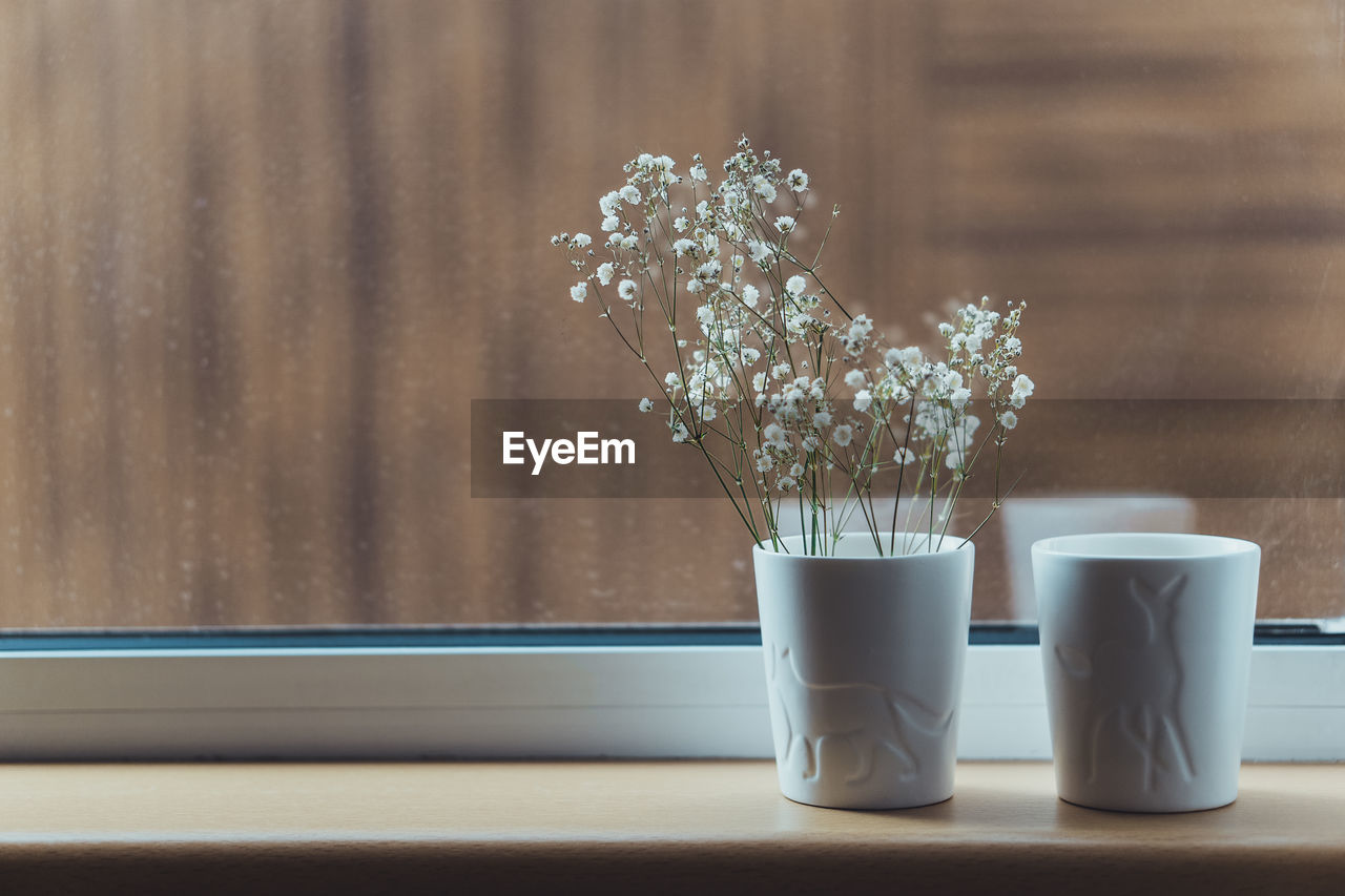 Close-up of flower vase on table