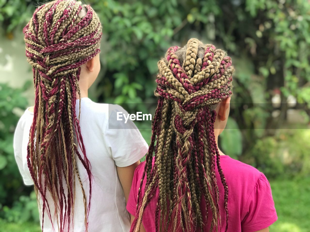 Rear view of girls with dreadlocks at park