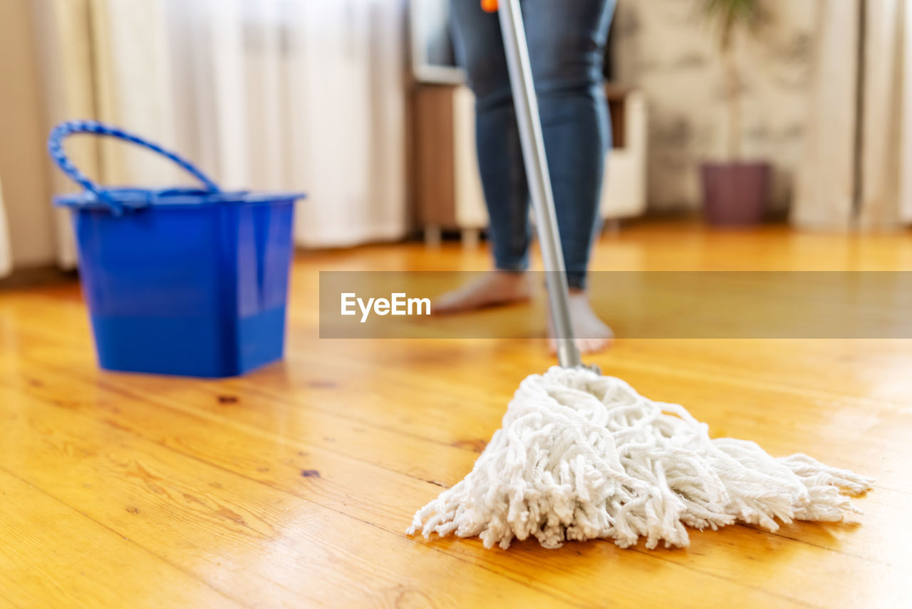 low section of person with blue floor at home