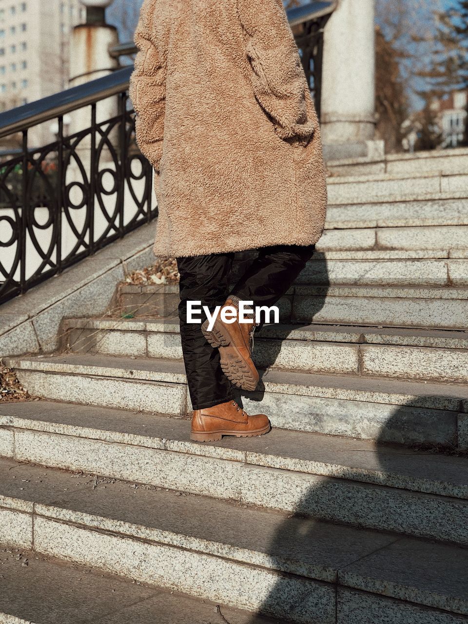 Low section of woman walking on staircase