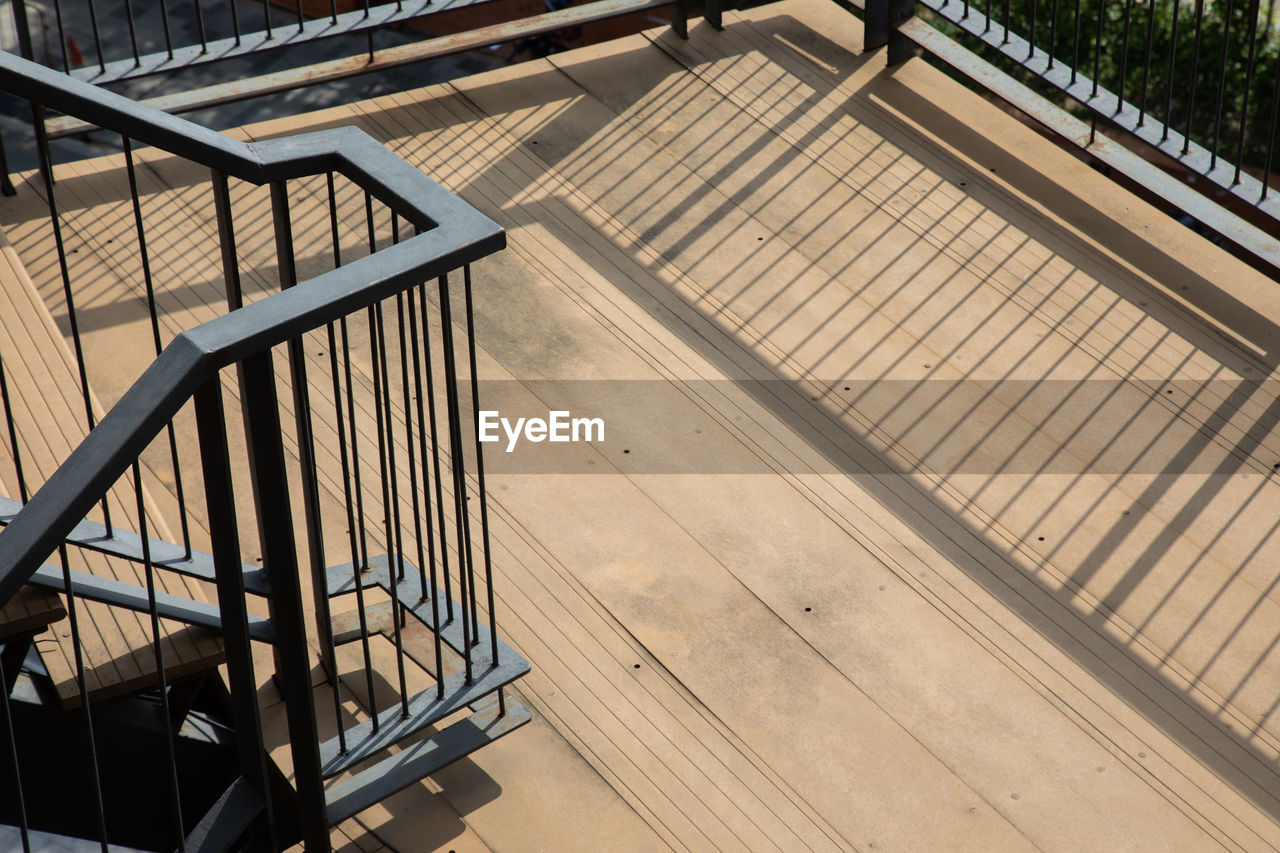 HIGH ANGLE VIEW OF EMPTY STAIRCASE IN SUNLIGHT