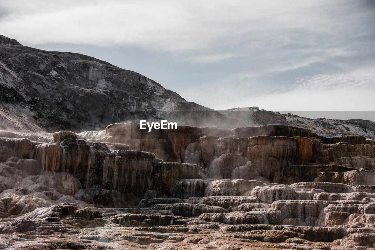 View of landscape with mountain range in background