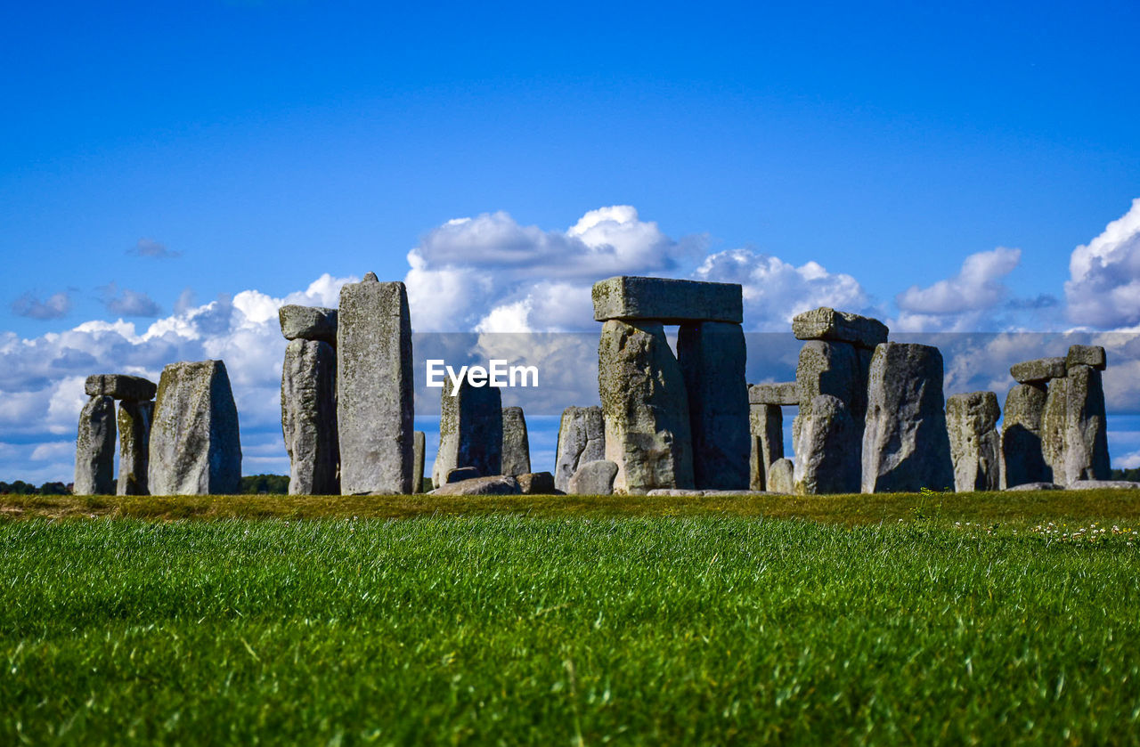 View of rock formations on field against sky