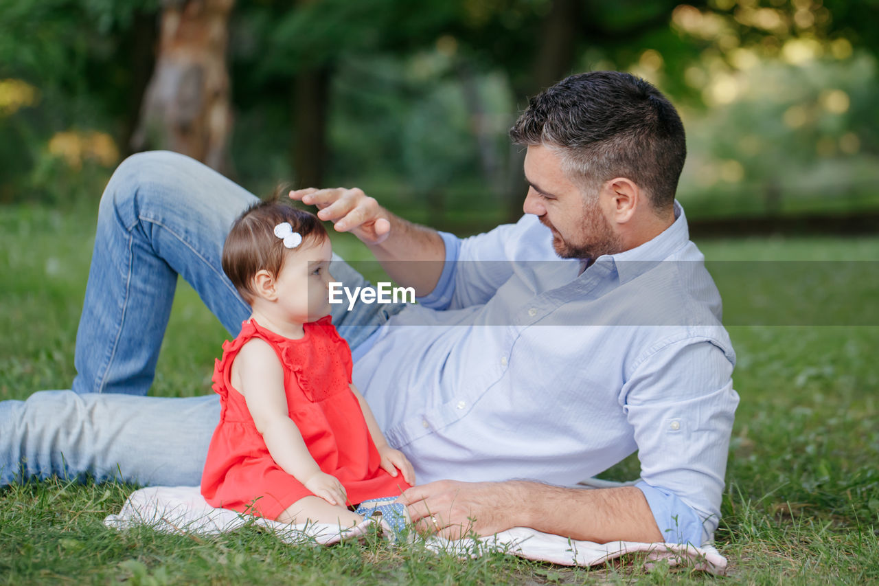 Fathers day. middle age caucasian proud father playing with baby daughter. family dad and daughter 