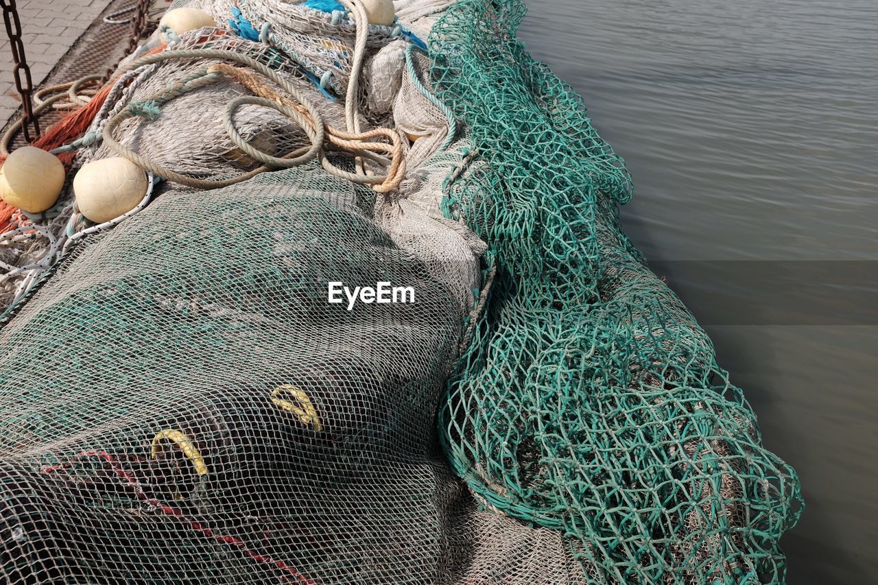 High angle view of fishing net in boat on sea