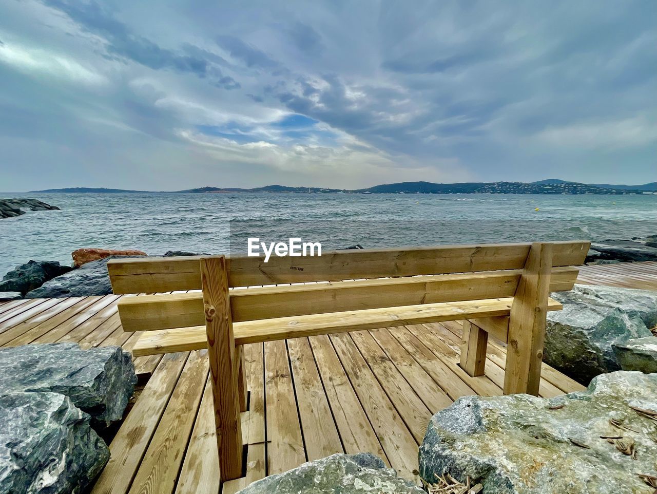 water, sea, shore, sky, ocean, coast, wood, scenics - nature, nature, beach, land, vacation, beauty in nature, tranquility, cloud, tranquil scene, no people, rock, pier, environment, travel destinations, travel, landscape, day, outdoors, horizon, holiday, relaxation, seascape, idyllic, bay, trip, summer, horizon over water, non-urban scene, jetty, seat, coastline, body of water, sunlight, tourism, bench, sand, wave, architecture