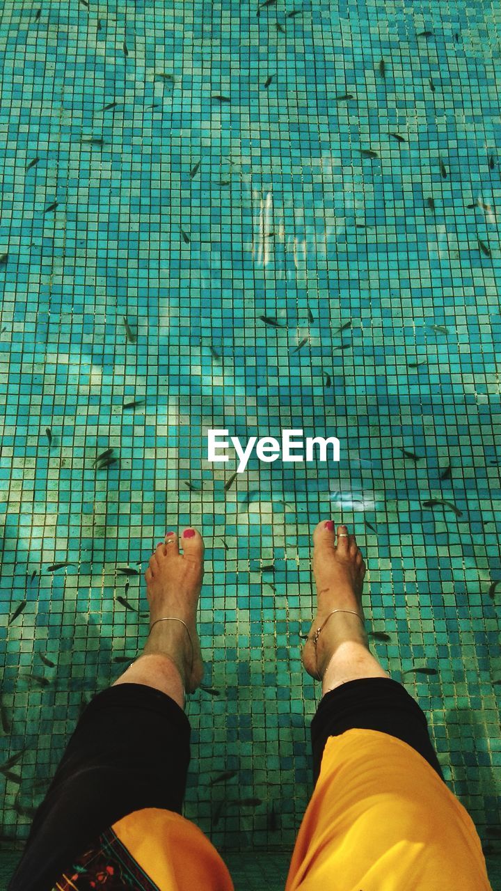 Low section of woman at swimming pool