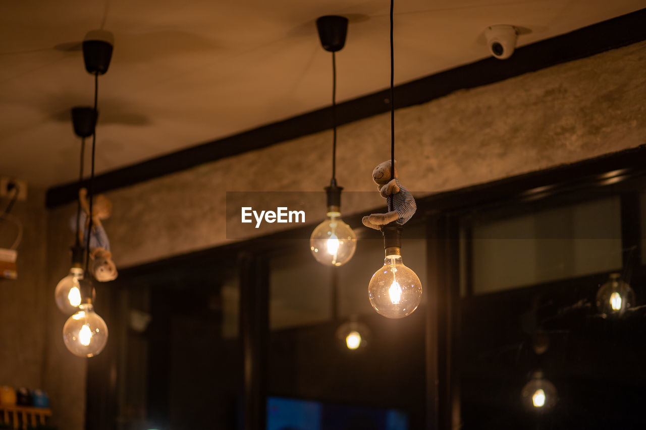 LOW ANGLE VIEW OF ILLUMINATED PENDANT LIGHT