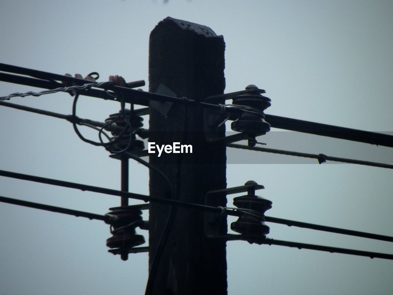 LOW ANGLE VIEW OF SILHOUETTE TELEPHONE POLE AGAINST CLEAR SKY