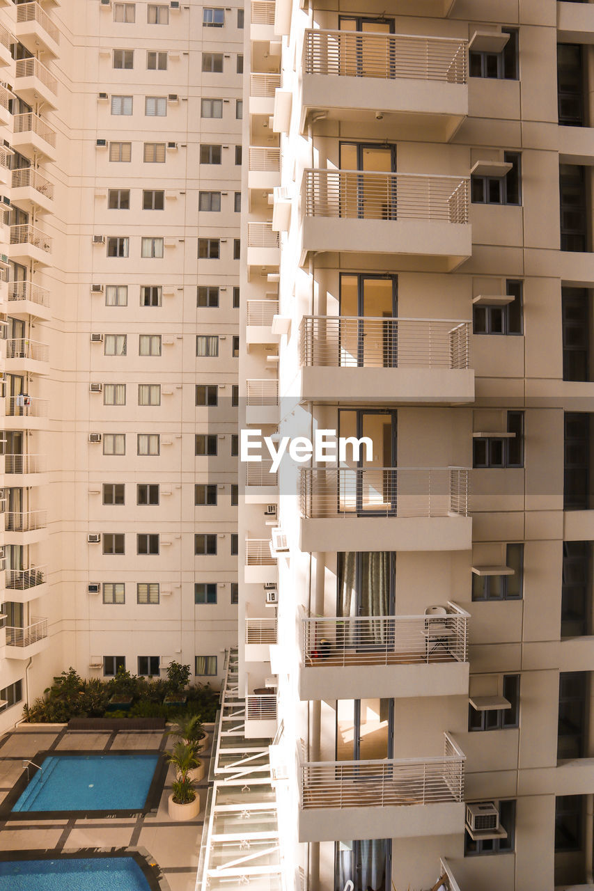 architecture, building exterior, built structure, building, condominium, tower block, apartment, city, residential district, window, no people, skyscraper, facade, residential area, interior design, day, outdoors, balcony, window covering, furniture, home ownership, house