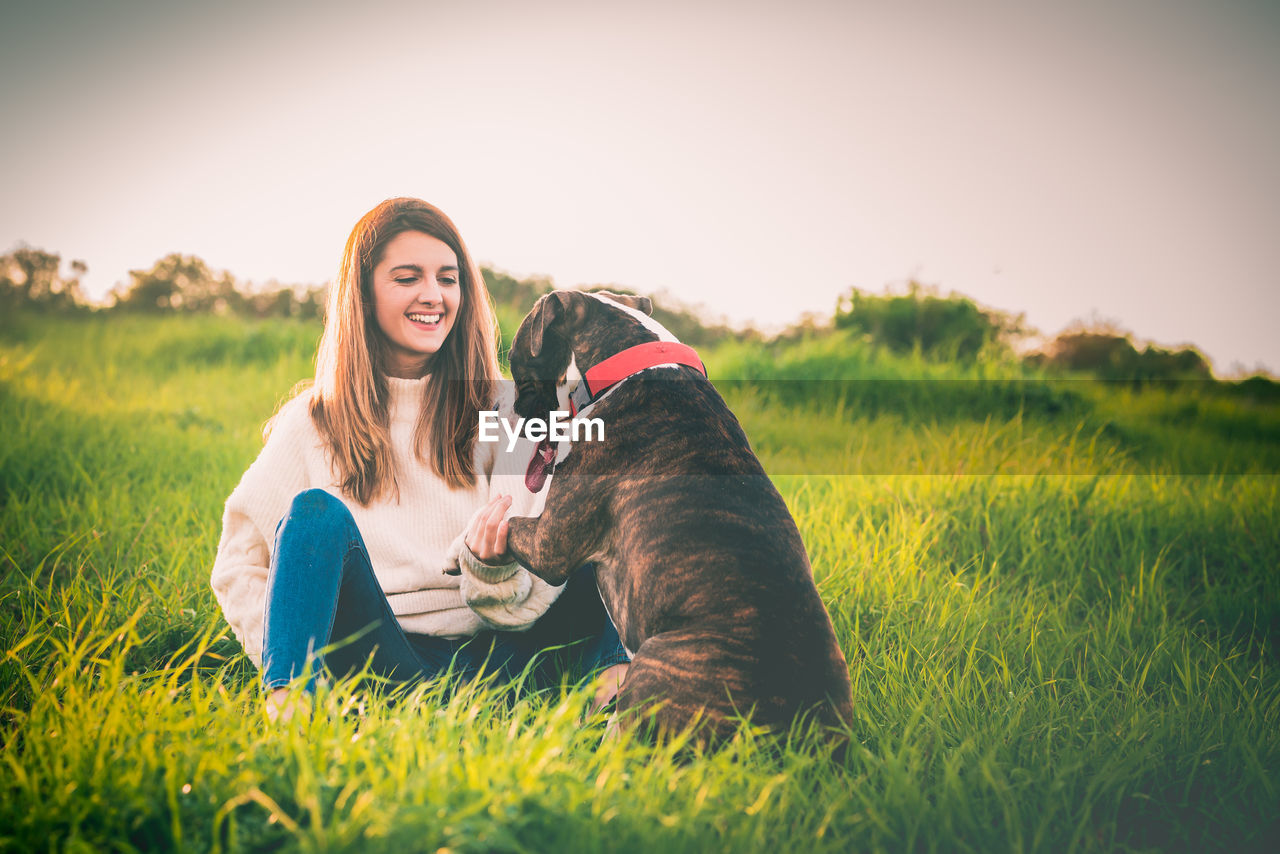 Woman with dog on field