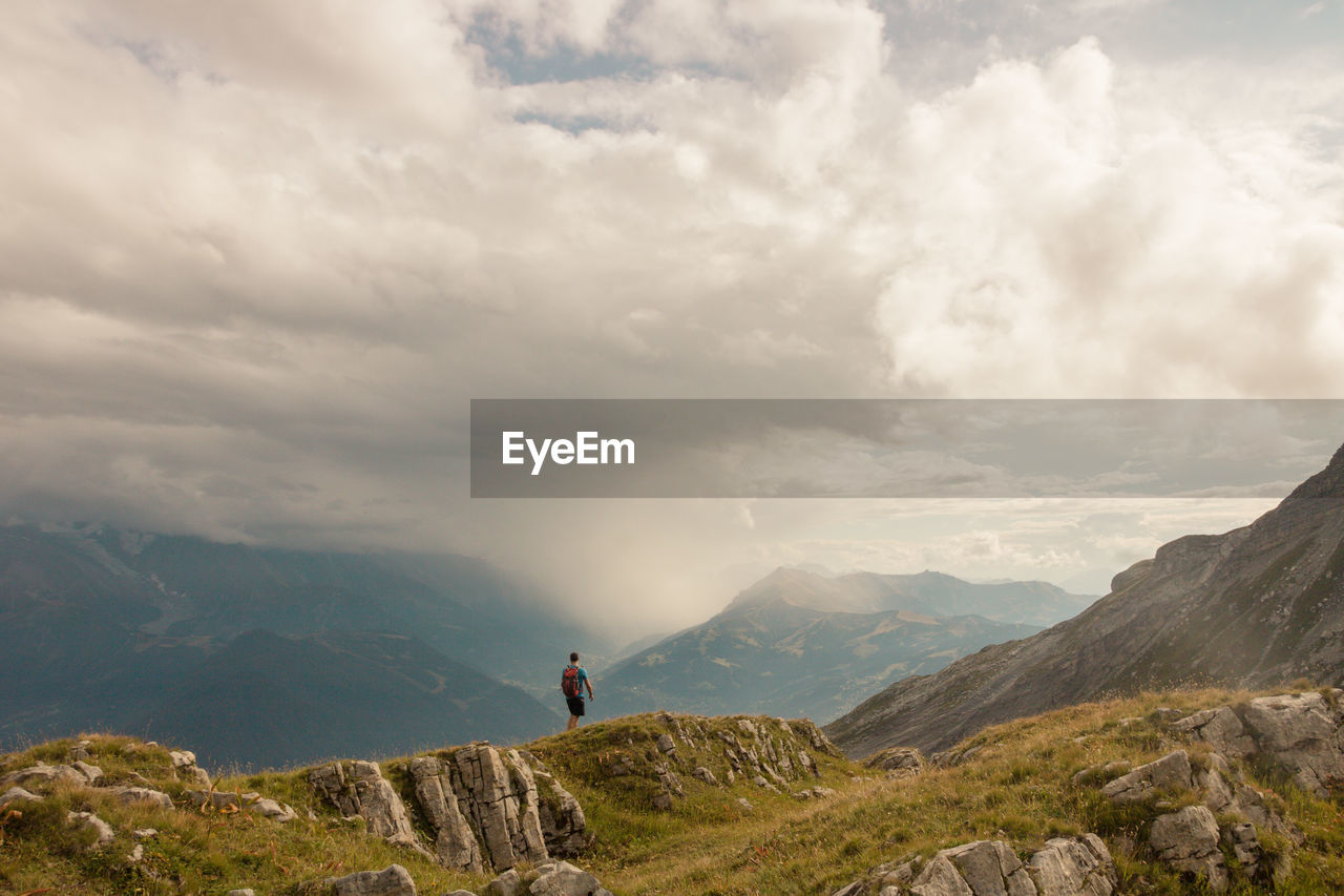 People on mountain against sky