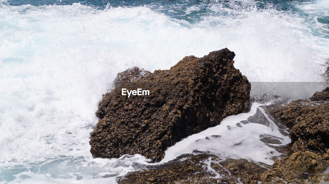 Close-up of waves splashing on rock