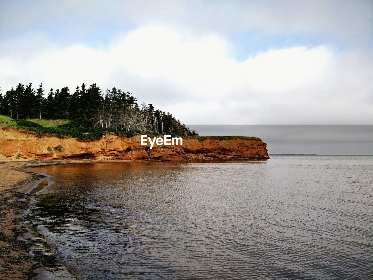 Scenic view of sea against cloudy sky