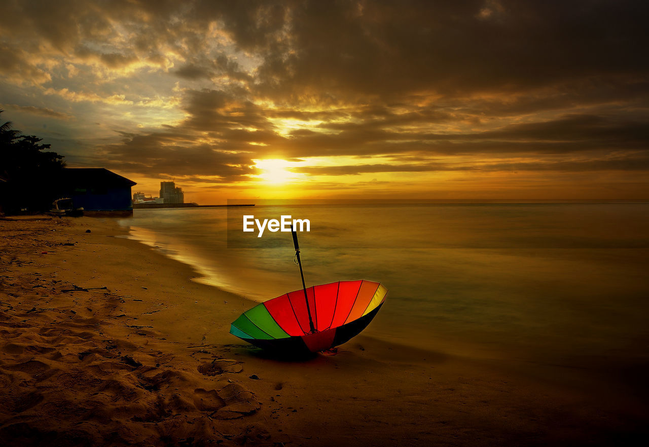 Scenic view of beach against sky during sunset