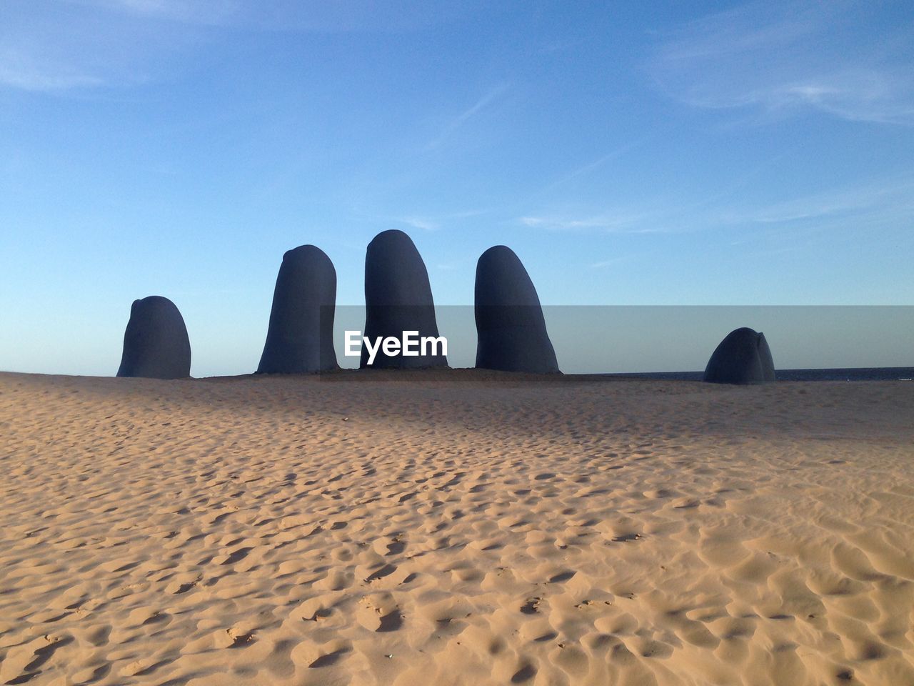 PANORAMIC VIEW OF SAND DUNE AGAINST CLEAR BLUE SKY