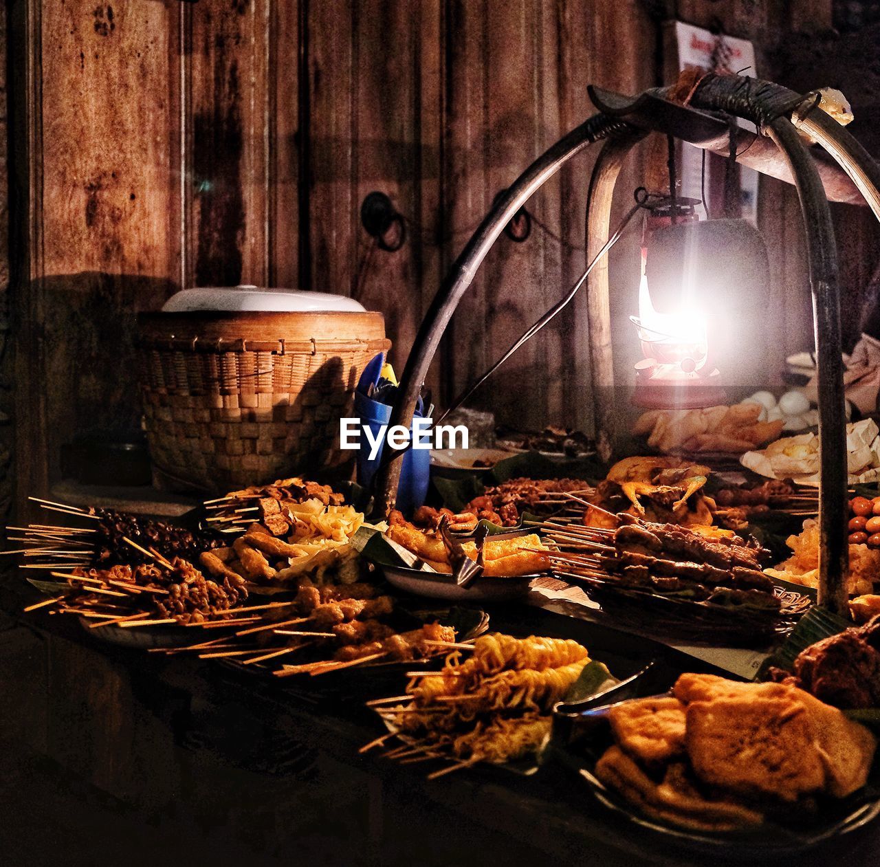 Barbecued food displayed at market stall during night