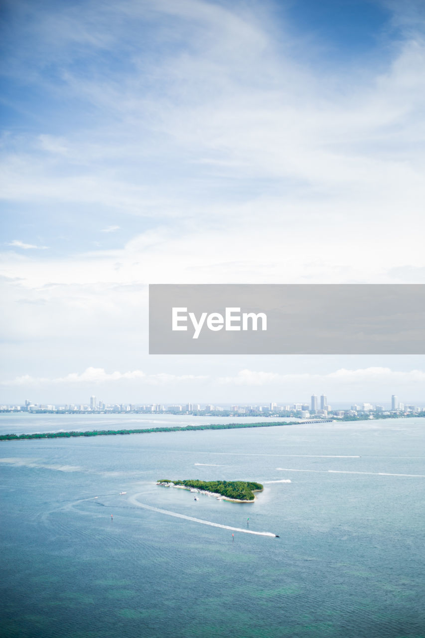 Aerial view of biscayne bay against cloudy sky