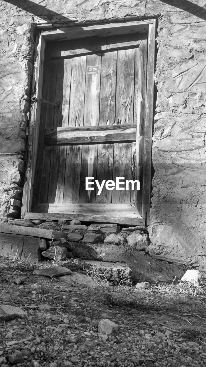 CLOSED WOODEN DOOR OF HOUSE