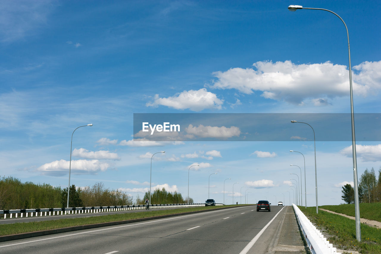 A road under the blue sky with clouds