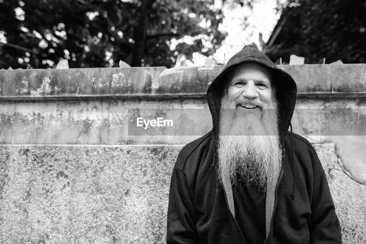 Portrait of smiling man standing outdoors