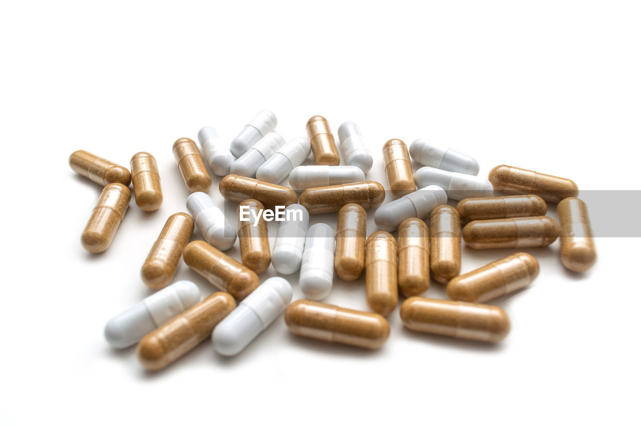 High angle view of capsules on white background