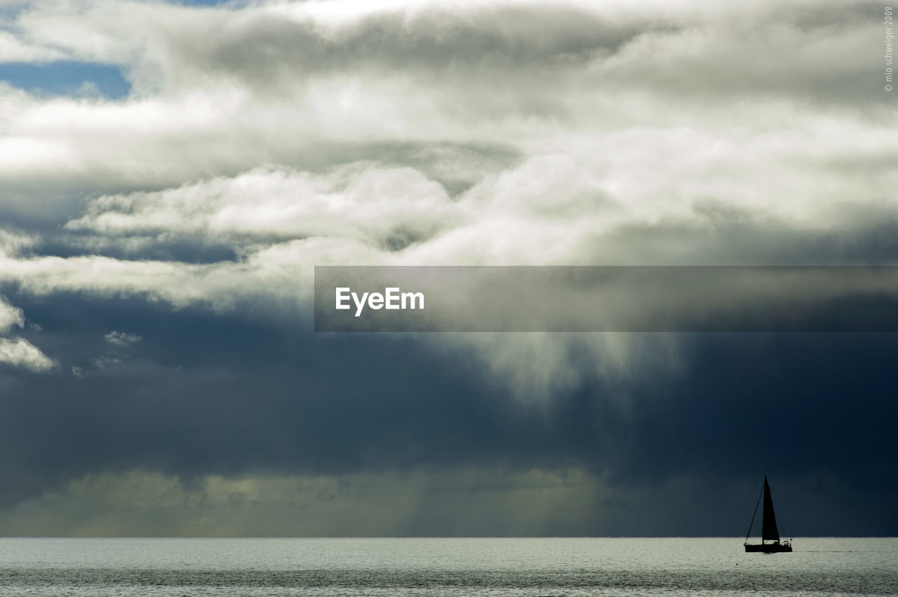 Scenic view of sea against storm clouds