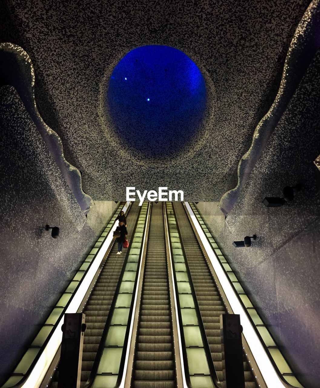 LOW ANGLE VIEW OF ESCALATOR AT NIGHT