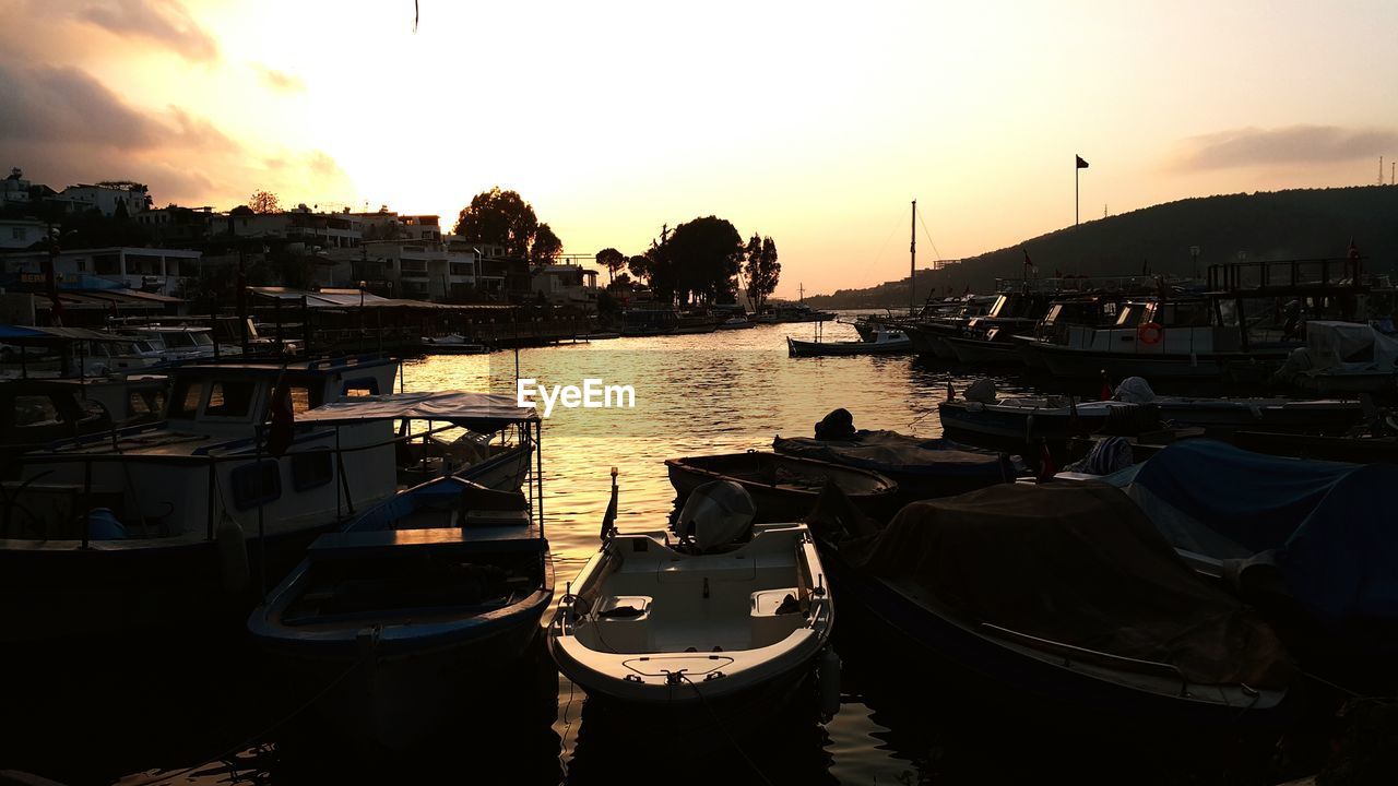 BOATS IN RIVER AT SUNSET