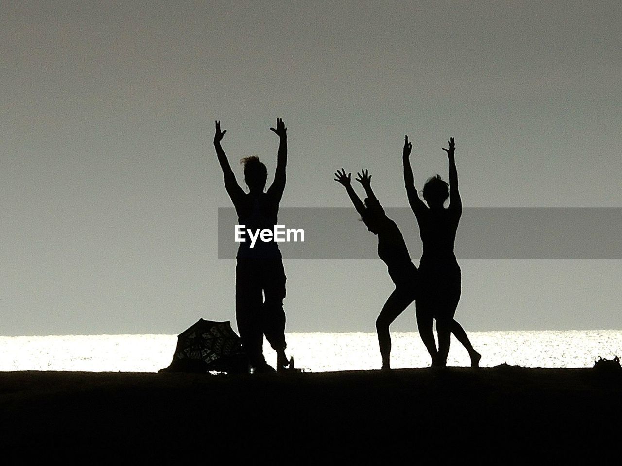 SILHOUETTE PEOPLE AT BEACH AGAINST SKY